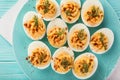 Stuffed eggs with smoked paprika on blue plate for easter table