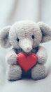 A stuffed elephant holding a red heart, AI