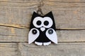 Stuffed felt owl ornament on an old wooden background with empty copy space. DIY sewing crafts from felt. Owl crafts