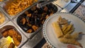stuffed and gratinated mussels and spring rolls in a buffet restaurant Royalty Free Stock Photo