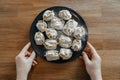 Stuffed homemade dumplings, manti of dough and minced on a dark plate