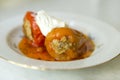 stuffed with meat 2 two with delicious pepper sauce and sour cream on the plate, dish Royalty Free Stock Photo