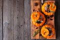 Stuffed fall mini pumpkins with rice, cranberries, cabbage and nuts above view on platter over rustic wood