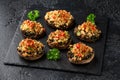 Stuffed mushrooms with spinach, bread crumbs and cheese on stone board Royalty Free Stock Photo