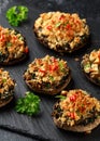 Stuffed mushrooms with spinach, bread crumbs and cheese on stone board Royalty Free Stock Photo