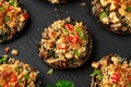 Stuffed mushrooms with spinach, bread crumbs and cheese on stone board Royalty Free Stock Photo