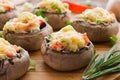 Stuffed mushrooms with vegetables on wooden board Royalty Free Stock Photo