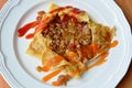 Stuffed omelet with onion and minced pork dressing sauce on plate