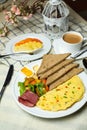 Stuffed Omelette with bown bread, meat, vegetable salad include tomato, potato, lettuce leaf and carrot with tea, coffee, and Royalty Free Stock Photo