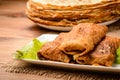 Stuffed pancakes on wooden background. Royalty Free Stock Photo