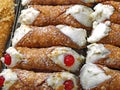 stuffed pastries with red cherry in pastry called CANNOLI SICILI