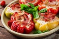 Stuffed peppers with cottage cheese and bacon in plate on the wooden table. Royalty Free Stock Photo