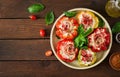 Stuffed peppers with cottage cheese and bacon in plate on the wooden table. Royalty Free Stock Photo