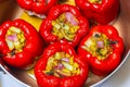 Stuffed peppers. Six large red bell peppers stuffed and ready for the table Royalty Free Stock Photo