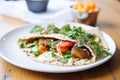 stuffed pita pocket with falafel and creamy tahini