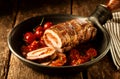 Stuffed pork roast and tomatoes in pan Royalty Free Stock Photo