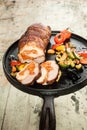 Stuffed pork roast and vegetables on pan Royalty Free Stock Photo