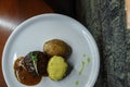 Stuffed potatoes with cheese and with meat grilled with barbecue sauce on the bar table. Great lunch for gourmets. Royalty Free Stock Photo