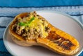 Stuffed roasted butternut - mince and cheese filled butternut squash close up Royalty Free Stock Photo