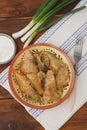 Stuffed Rolled Cabbage meat in Leaves in a Ceramic Plate with White Napkin,Parsley on a Rustic Wooden background. Traditional Roma Royalty Free Stock Photo