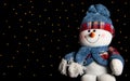 snowman on black background with defocused lights