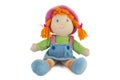 Stuffed soft sitting funny pig-tailed red-headed doll Royalty Free Stock Photo