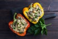 Stuffed sweet peppers with rice mushrooms and cheese with herbs. Baked halves of red and yellow peppers with filling Royalty Free Stock Photo