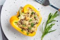 Stuffed sweet peppers with rice mushrooms and cheese with herbs. Baked halves of yellow peppers with filling. White Royalty Free Stock Photo