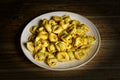 Stuffed tortellini not cooked on the plate - traditional Italian food