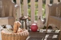 Stuffed toy easter bunny sitting on a straw chair on the veranda, looking to the sun Royalty Free Stock Photo
