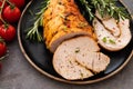 Stuffed turkey breast with baked vegetables and spices on a black background. Royalty Free Stock Photo