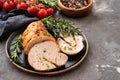 Stuffed turkey breast with baked vegetables and spices on a black background. Royalty Free Stock Photo