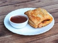 Stuffed vegetable puff, famous Indian Bakery snack, served with Tomato Ketchup