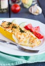 Stuffed zucchini with chicken and vegetables, dark background