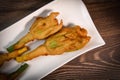 Stuffed zucchini flower on plate. Royalty Free Stock Photo