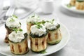 Stuffed zucchini rolls on grey marble closeup