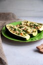 Stuffed zucchini with turkey, tomato, cheese and spring onion on a green plate Royalty Free Stock Photo