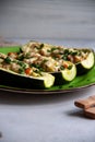 Stuffed zucchini with turkey, tomato, cheese and spring onion on a green plate Royalty Free Stock Photo