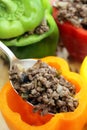 Stuffing colourful peppers vertical