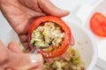 Stuffing the emptied tomatoes