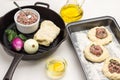 Stuffing of meat on pieces of raw dough on baking pan Royalty Free Stock Photo