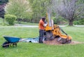 Worker grinds up a stump with a large machine Royalty Free Stock Photo