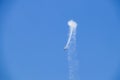Stund plane doing a loop with smoke in turquoise blue sky Royalty Free Stock Photo