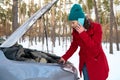 Stunned middle age Caucasian woman trying to fix car breakdown or engine failure and waiting for towing service for help car Royalty Free Stock Photo
