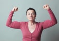 Stunned 40s woman showing her emphasized strength