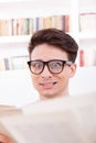Stunned student surrounded by books Royalty Free Stock Photo