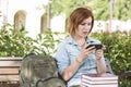 Stunned Young Female Student Outside Texting on Cell Phone Royalty Free Stock Photo