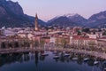 Stunning aerial cityscape of Lecco town on spring evening. Picturesque waterfront of Lecco town located between famous Lake Como
