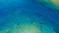 Stunning aerial drone image of a great coral reef marine channel in calm weather flat water and incredible colorful sea ocean bed