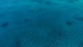 Stunning aerial drone image of a a small fishing boat entering an a sea ocean anchorage in a channel next to a coral reef in